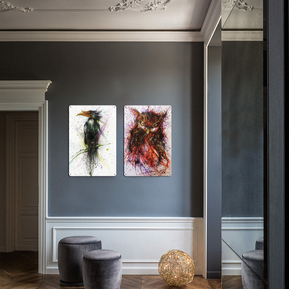 Two abstract paintings on a wall in a stylish interior setting with decorative elements.