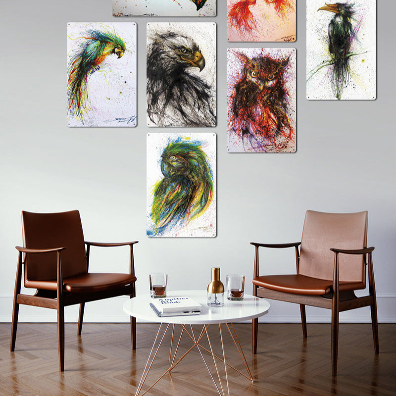 Room interior with abstract animal paintings on the wall, two chairs, and a coffee table.