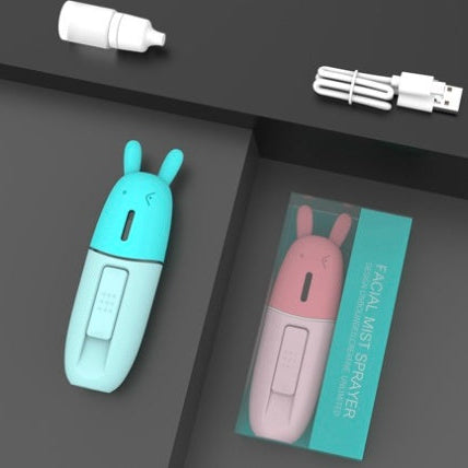 Facial mist sprayer with rabbit design on a gray surface