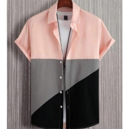 Color-blocked shirt with pink, gray, and black sections on a textured background
