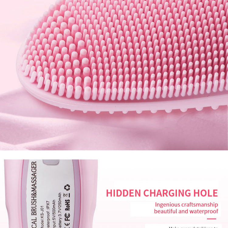 Pink silicone facial cleansing brush with charging feature on a white background