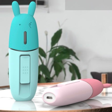 Two colorful cartoon-style bottles on a reflective surface with a blurred indoor background