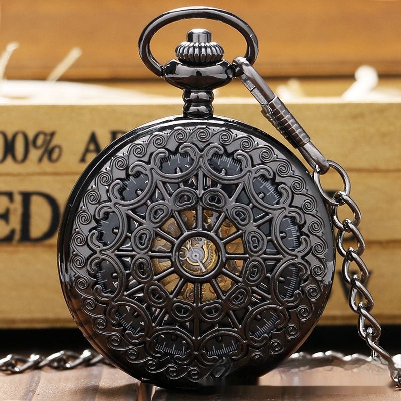 Decorative pocket watch with intricate designs on a wooden surface