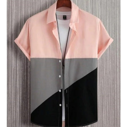 Color-blocked shirt with pink, gray, and black sections on a textured background