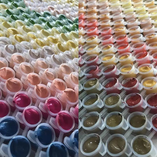 Two rows of small containers filled with colorful liquids on a white background