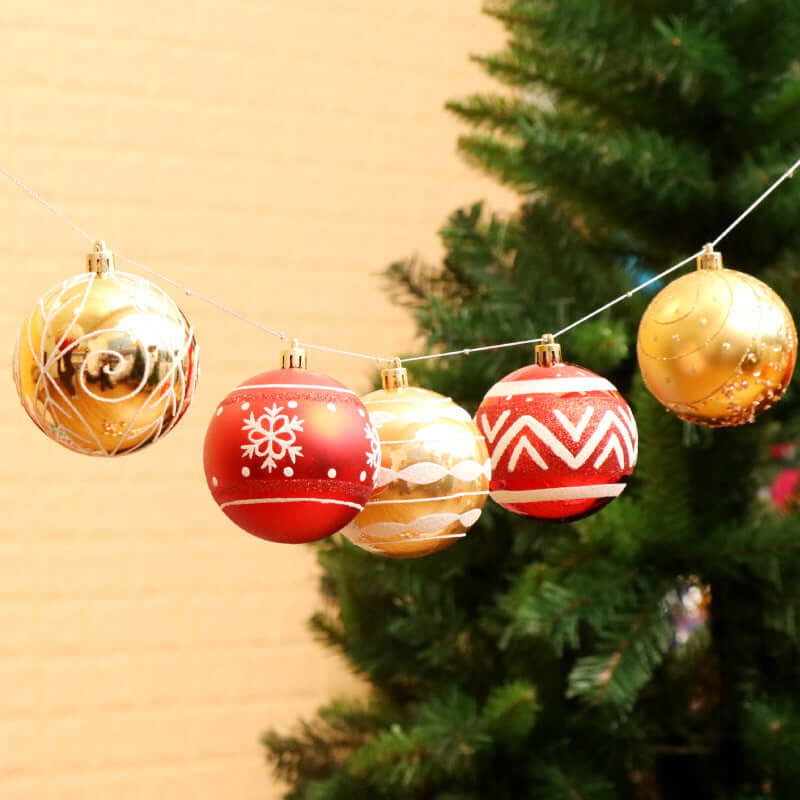 6cm Christmas tree decorations in red and gold hanging on a string, adding festive charm to holiday decor.
