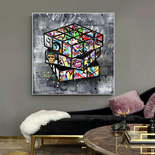 Colorful abstract art piece on a gray wall above a black sofa with decorative pillows.