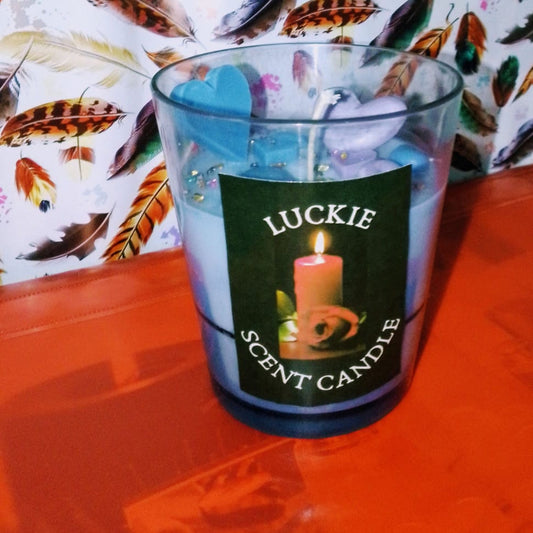 Candle in a glass container with a label on a colorful background