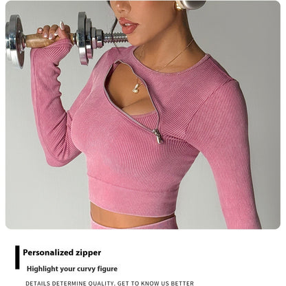 Person wearing a pink long-sleeve top with a personalized zipper, lifting a dumbbell.
