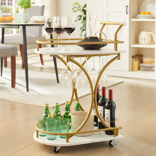 Gold and white bar cart with wine bottles, glasses, and a decanter in a home setting.