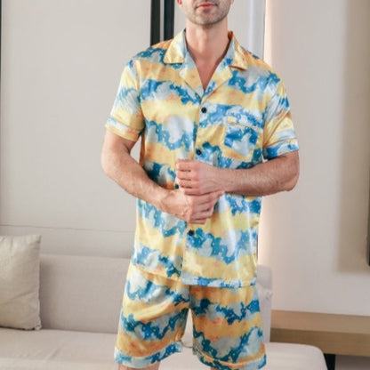 Man wearing a yellow and blue patterned pajama set in a living room.
