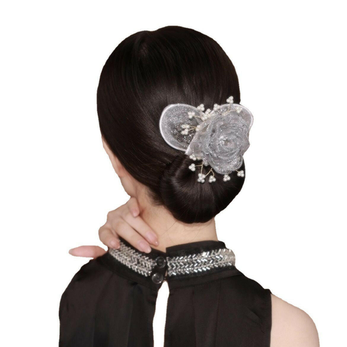 Woman with a decorative hair clip and black top on a white background